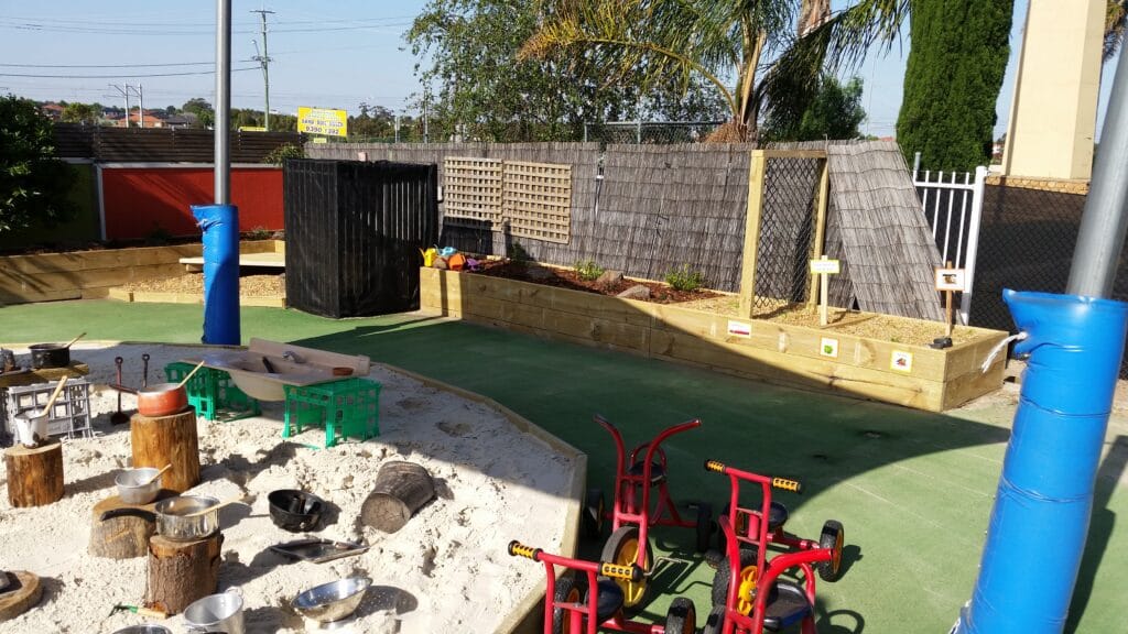 Commercial playground with soft-fall surfaces and timber cubby, Melbourne