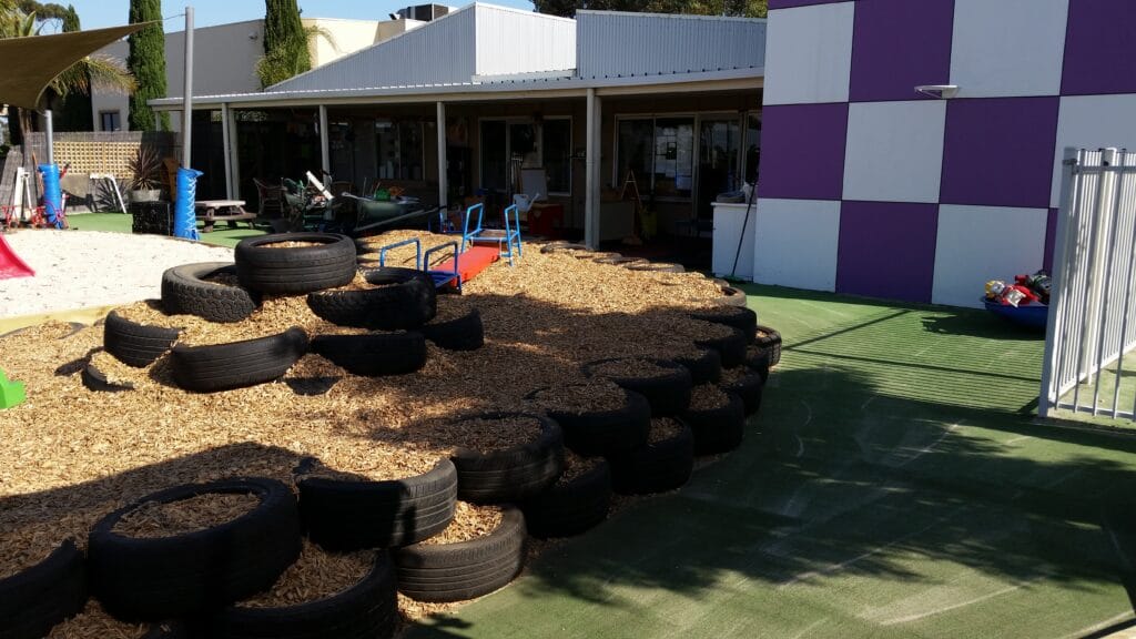 Recycled tyre obstacle course in childcare landscaping, Melbourne west