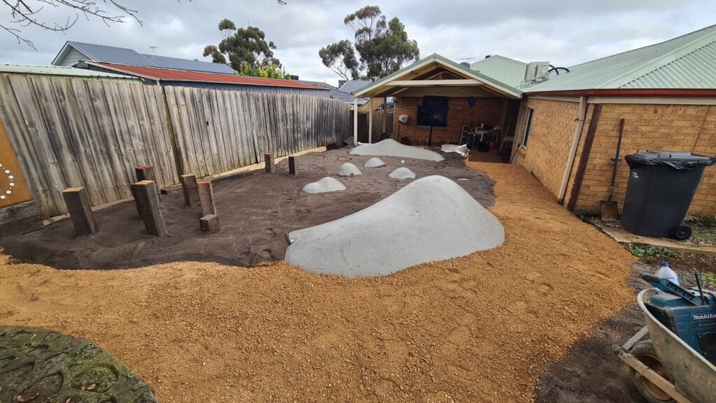 Rubber soft-fall surfacing and Corten steel privacy screens, commercial landscaping Melbourne