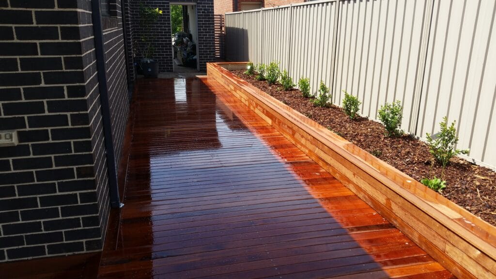Hardwood timber decking installation with garden bed, Melbourne west