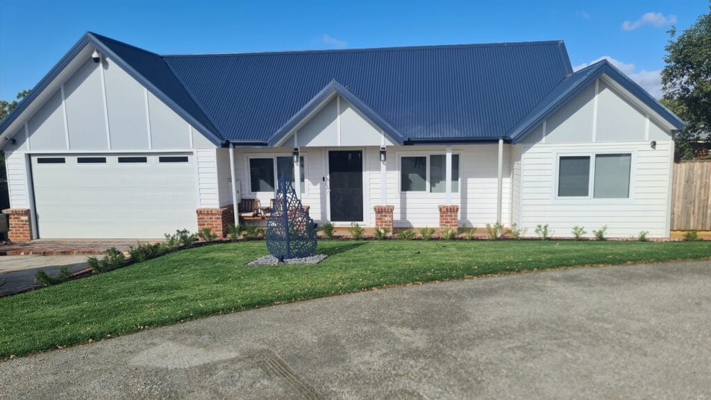 Hamptons-style front garden with circular lawn and exposed aggregate driveway, Bacchus Marsh